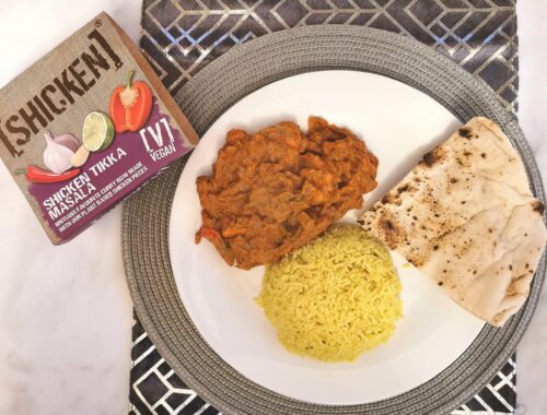 Shicken tikka masala plated with pilau rice and naan bread